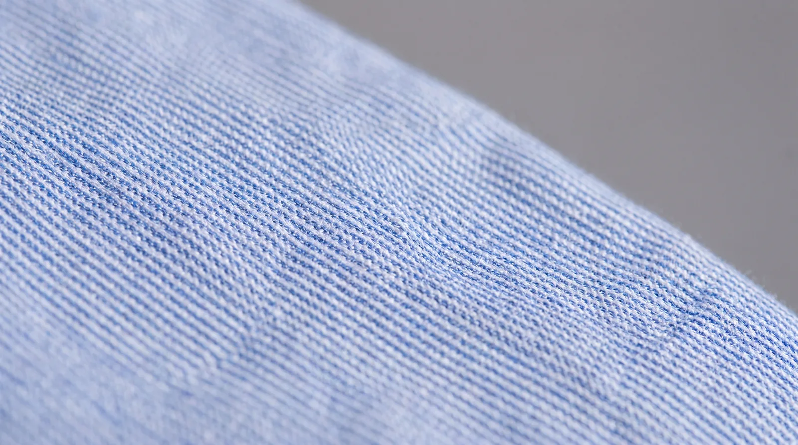 Editorial photograph of a finely striped shirt showing moire pattern artifacts
